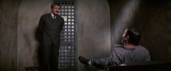 Movie still from “The Molly Maguires” (1970), directed by Martin Ritt – A man standing in front of a jail cell; Medium shot, High angle