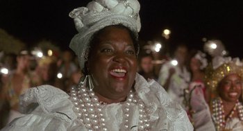Movie still from “The Money Pit” (1986), directed by Richard Benjamin – A person wearing a dress and a hat; Close Up shot, Low angle