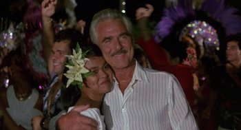 Movie still from “The Money Pit” (1986), directed by Richard Benjamin – An older man and a young woman posing for a picture; Close Up shot, Low angle