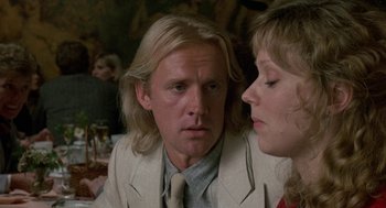 Movie still from “The Money Pit” (1986), directed by Richard Benjamin – A man and a woman sitting at a dinner table; Close Up shot, Over the shoulder angle