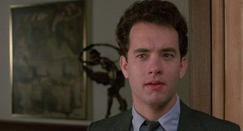 Movie still from “The Money Pit” (1986), directed by Richard Benjamin – A person wearing a suit and tie; Close Up shot, Low angle