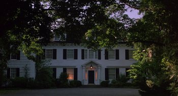 Movie still from “The Money Pit” (1986), directed by Richard Benjamin – A large white house sitting in the middle of the night; Extreme Wide shot, Low angle