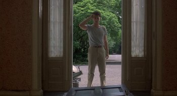 Movie still from “The Money Pit” (1986), directed by Richard Benjamin – A man standing in front of an open door; Wide shot, Low angle