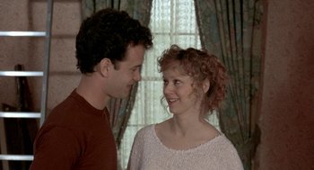 Movie still from “The Money Pit” (1986), directed by Richard Benjamin – A man and a woman smiling at each other; Close Up shot, Over the shoulder angle