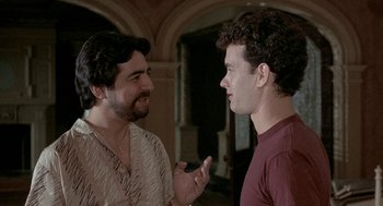 Movie still from “The Money Pit” (1986), directed by Richard Benjamin – A couple of men standing next to each other; Close Up shot, Over the shoulder angle