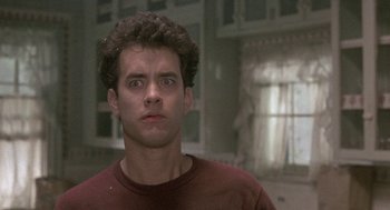 Movie still from “The Money Pit” (1986), directed by Richard Benjamin – A person wearing a red t - shirt; Close Up shot, Low angle