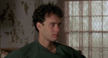 Movie still from “The Money Pit” (1986), directed by Richard Benjamin – A person wearing a green shirt; Close Up shot, Over the shoulder angle