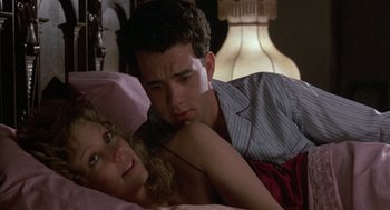 Movie still from “The Money Pit” (1986), directed by Richard Benjamin – A man and a woman laying in a bed together; Close Up shot, Over the shoulder angle
