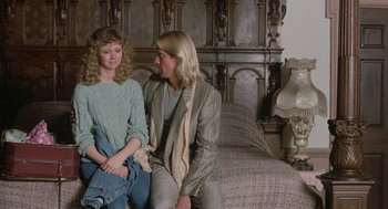 Movie still from “The Money Pit” (1986), directed by Richard Benjamin – Two women sitting on a bed next to each other; Medium shot, Overhead angle