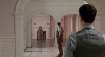 Movie still from “The Money Pit” (1986), directed by Richard Benjamin – A man and a woman standing in a room; Wide shot, Over the shoulder angle