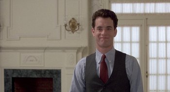 Movie still from “The Money Pit” (1986), directed by Richard Benjamin – A man in a vest and a red neck tie; Medium shot, Low angle