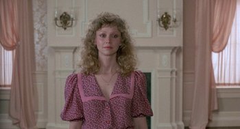 Movie still from “The Money Pit” (1986), directed by Richard Benjamin – A woman with long blonde hair wearing a pink and purple dress; Medium shot, Low angle