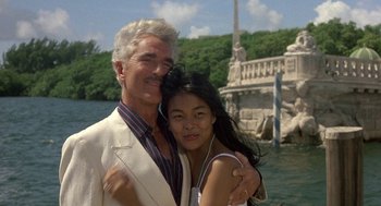 Movie still from “The Money Pit” (1986), directed by Richard Benjamin – An older man and a young woman posing for a picture; Medium shot, Low angle