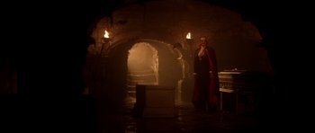 Movie still from “The Monster Squad” (1987), directed by Fred Dekker – A man standing in front of a fire place; Extreme Wide shot, Low angle