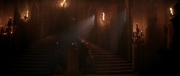 Movie still from “The Monster Squad” (1987), directed by Fred Dekker – A staircase in a building lit up by candles; Extreme Wide shot, High angle