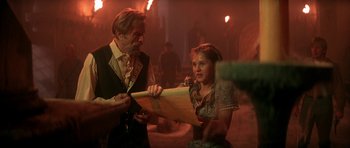 Movie still from “The Monster Squad” (1987), directed by Fred Dekker – A man and a woman looking at a piece of paper; Medium shot, Over the shoulder angle