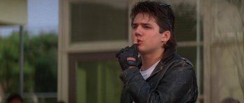 Movie still from “The Monster Squad” (1987), directed by Fred Dekker – A young man in a leather jacket smoking a cigarette; Close Up shot, Over the shoulder angle
