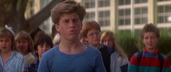 Movie still from “The Monster Squad” (1987), directed by Fred Dekker – A young man is standing in front of a group of people; Close Up shot, Low angle