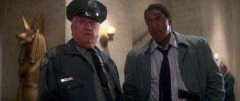 Movie still from “The Monster Squad” (1987), directed by Fred Dekker – Two police officers standing next to each other in a hallway; Medium shot, Low angle