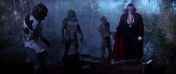 Movie still from “The Monster Squad” (1987), directed by Fred Dekker – A group of people dressed as monsters in a dark forest; Wide shot, High angle