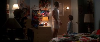 Movie still from “The Monster Squad” (1987), directed by Fred Dekker – A man and a boy are standing in a bedroom; Wide shot, Low angle