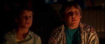 Movie still from “The Monster Squad” (1987), directed by Fred Dekker – Two young boys sitting in front of a television; Close Up shot, Low angle