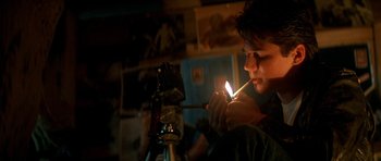 Movie still from “The Monster Squad” (1987), directed by Fred Dekker – A man lighting a candle in a dark room; Medium shot, Low angle