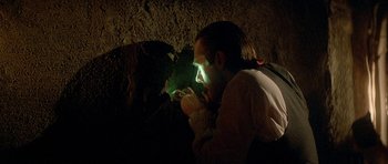 Movie still from “The Monster Squad” (1987), directed by Fred Dekker – A man with a flashlight in a cave; Close Up shot, Over the shoulder angle