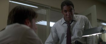 Movie still from “The Monster Squad” (1987), directed by Fred Dekker – A man wearing a white dress shirt and a red tie; Close Up shot, Over the shoulder angle