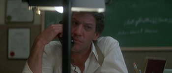 Movie still from “The Monster Squad” (1987), directed by Fred Dekker – A man talking on a phone while sitting at a desk; Close Up shot, Low angle