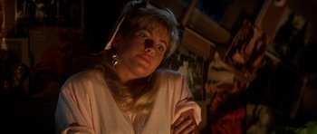 Movie still from “The Monster Squad” (1987), directed by Fred Dekker – A woman in a pink shirt is looking at the camera; Close Up shot, Low angle