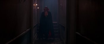 Movie still from “The Monster Squad” (1987), directed by Fred Dekker – A man dressed up as a vampire walks down a hallway; Wide shot, Low angle