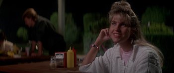 Movie still from “The Monster Squad” (1987), directed by Fred Dekker – A woman sitting at a table talking on a phone; Close Up shot, Over the shoulder angle