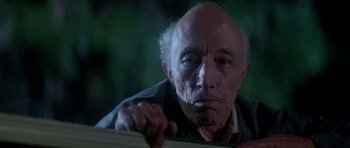 Movie still from “The Monster Squad” (1987), directed by Fred Dekker – An old man with a beard is leaning against a wall; Close Up shot, Low angle