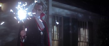 Movie still from “The Monster Squad” (1987), directed by Fred Dekker – A man dressed up as a vampire standing in front of a building; Medium shot, Low angle