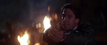 Movie still from “The Monster Squad” (1987), directed by Fred Dekker – A man holding a gun in his hand; Close Up shot, Low angle