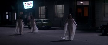 Movie still from “The Monster Squad” (1987), directed by Fred Dekker – A couple of people that are walking down the street; Wide shot, High angle