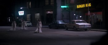 Movie still from “The Monster Squad” (1987), directed by Fred Dekker – A woman in a wedding dress walking down the street; Wide shot, Low angle