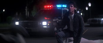 Movie still from “The Monster Squad” (1987), directed by Fred Dekker – A police car and a cop car on a street; Medium shot, Low angle