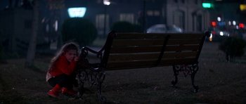 Movie still from “The Monster Squad” (1987), directed by Fred Dekker – A little boy sitting on the ground next to a bench; Wide shot, High angle