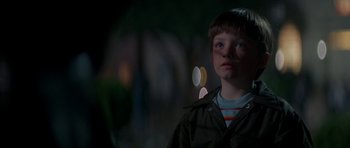Movie still from “The Monster Squad” (1987), directed by Fred Dekker – A young boy in a jacket looking at the camera; Close Up shot, Over the shoulder angle