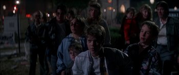 Movie still from “The Monster Squad” (1987), directed by Fred Dekker – A group of people standing in the dark at night; Medium shot, Over the shoulder angle