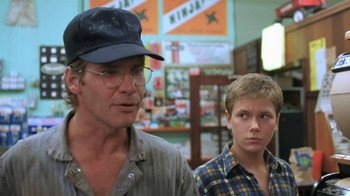 Movie still from “The Mosquito Coast” (1986), directed by Peter Weir – A man and a young boy standing next to each other; Medium shot, Low angle