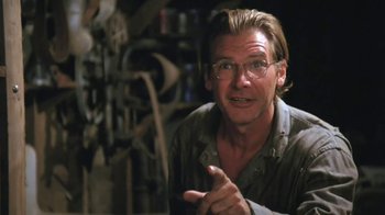 Movie still from “The Mosquito Coast” (1986), directed by Peter Weir – A man with glasses is talking in a room; Close Up shot, Low angle