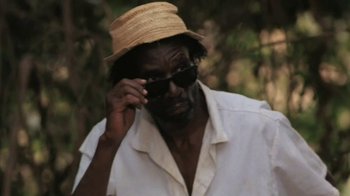 Movie still from “The Mosquito Coast” (1986), directed by Peter Weir – A man wearing a straw hat and a white shirt; Close Up shot, Low angle