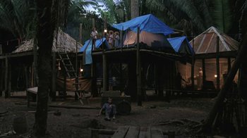 Movie still from “The Mosquito Coast” (1986), directed by Peter Weir – A group of people standing on top of a wooden structure; Wide shot, Low angle