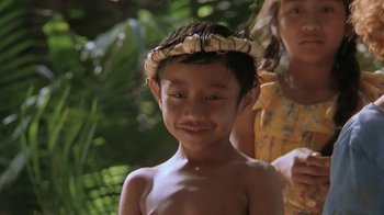 Movie still from “The Mosquito Coast” (1986), directed by Peter Weir – A young boy wearing a wreath of leaves; Close Up shot, Low angle