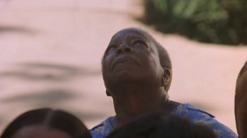 Movie still from “The Mosquito Coast” (1986), directed by Peter Weir – An older woman looking up into the sky; Close Up shot, Low angle