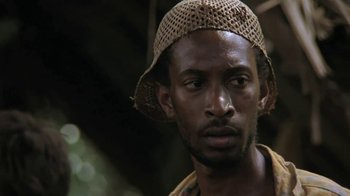 Movie still from “The Mosquito Coast” (1986), directed by Peter Weir – A person wearing a hat; Close Up shot, Low angle