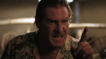 Movie still from “The Mosquito Coast” (1986), directed by Peter Weir – A person wearing glasses and a hawaiian shirt; Close Up shot, Low angle